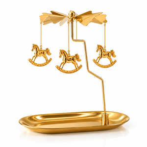 Golden candle carousel with tray and rocking horses, spinning above a lit candle - Eco Candle Project